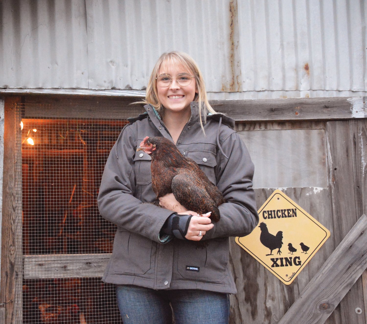 Adrian Brinkerhoff and her chicken, Harry, pose for a photo. Although her hens have avoided the most recent round of avian influenza, natural predators and higher feed prices are taking a toll on her backyard business.