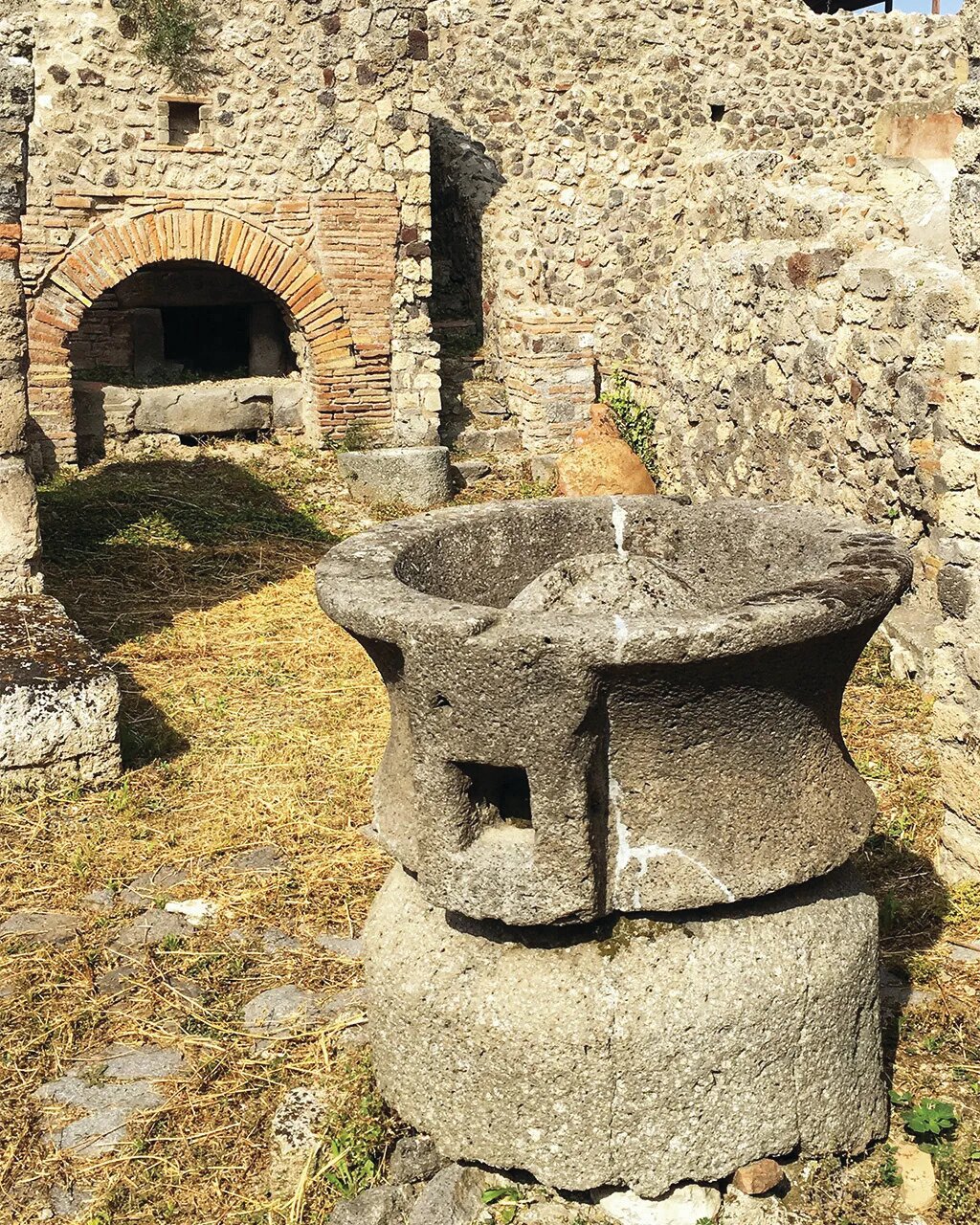 Ovens and millstones have been used around the world for thousands of years. This oven and millstone were discovered at the ancient site of Pompeii, which was covered by volcanic ash and debris in 79 A.D.