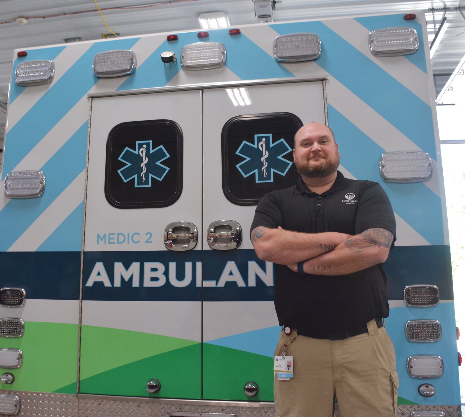MIH and RPM Coordinator Cody Muchow poses next to a Horizon Health ambulance. Muchow served as a paramedic for 17 years before becoming a registered nurse. Now he uses experience in a new format, bringing quality healthcare directly to patients.
