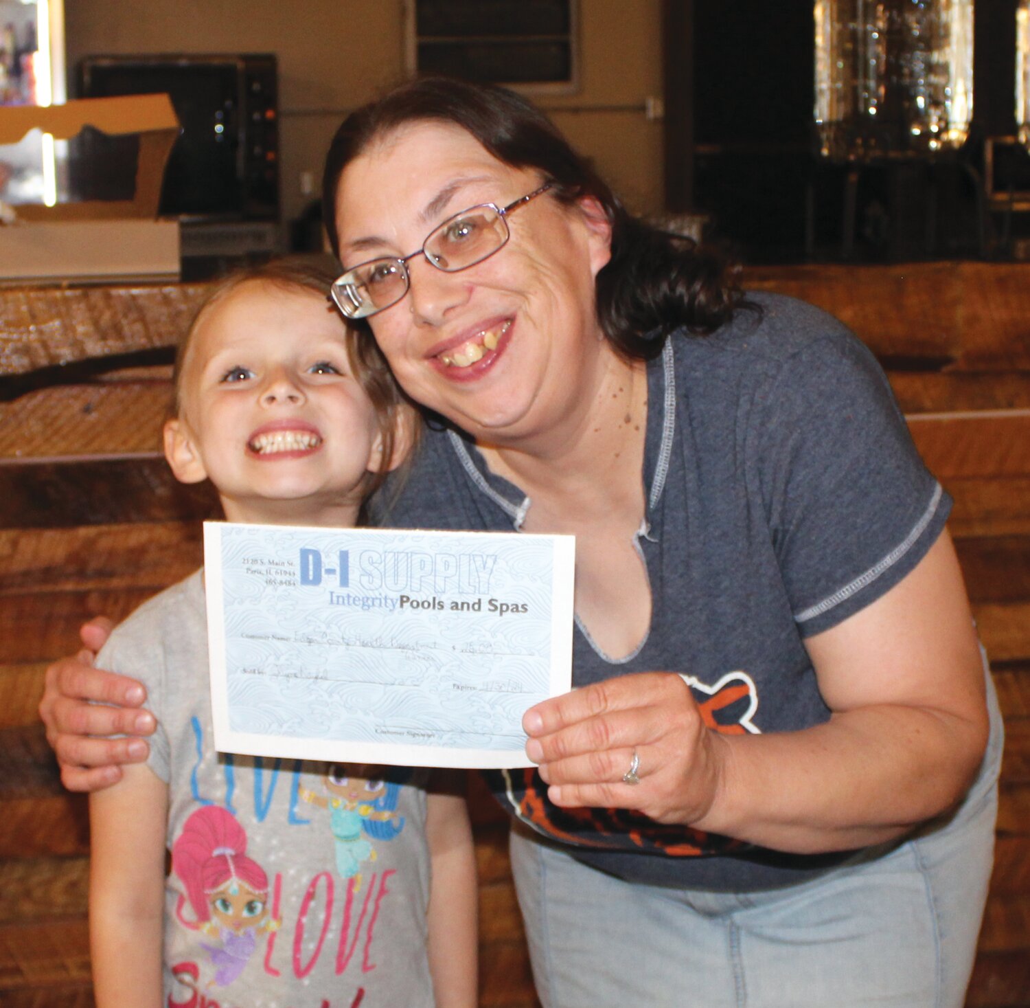 Elizabeth Garvin, 5, and her mother Robin Garvin were door prize winners at the Celebrate Families event. They received a gift certificate from D-I Supply.