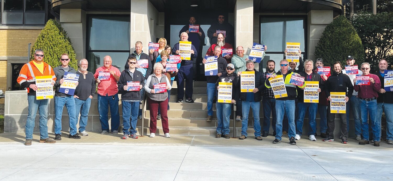 IDOT employees hold signs showing their support for Teamsters following a recent strike authorization vote.